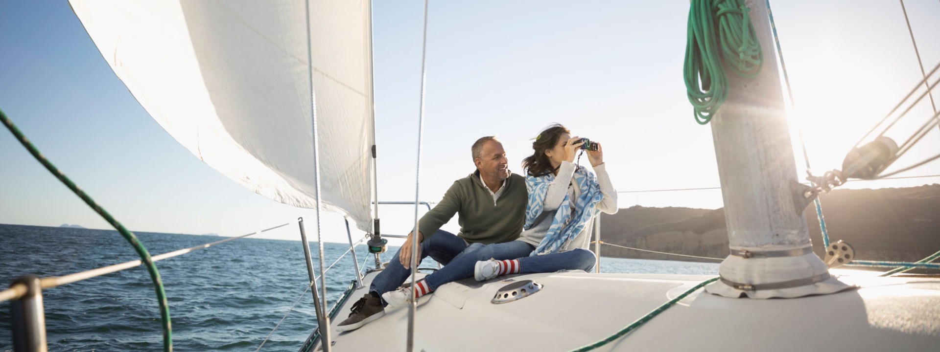 A man and a woman enjoying traveling by yacht